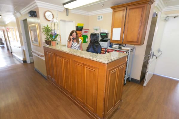 Reception area with staff assisting visitors