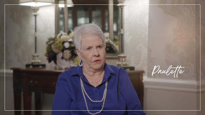 Resident sharing her story in a cozy interior setting