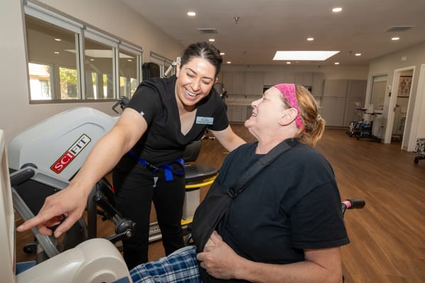 Staff assisting a resident in a therapy session