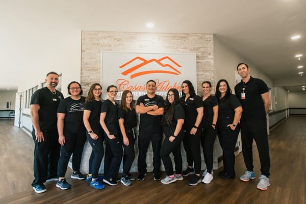 Staff members posing in the facility lobby