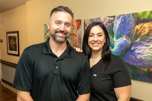 Staff members smiling in a bright hallway