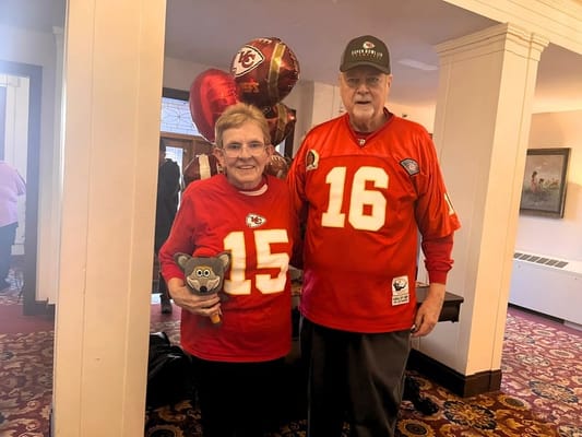 Residents celebrating in a common area wearing sports jerseys