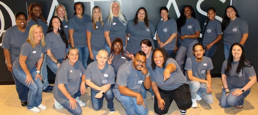 Staff members posing together in Atlas shirts