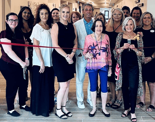 Ribbon-cutting ceremony with staff and residents celebrating