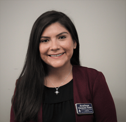 Staff member smiling while wearing a name badge