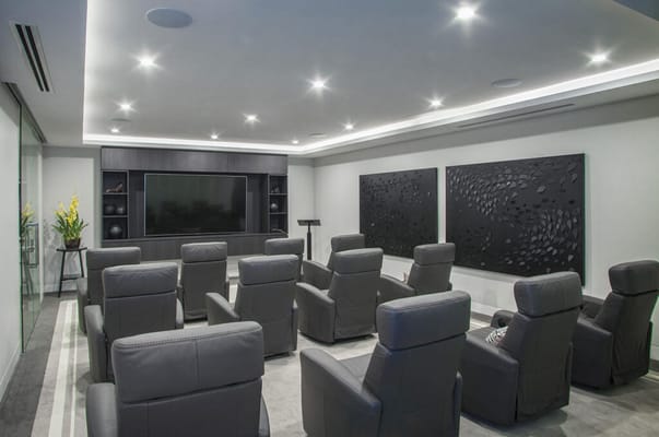 Interior common area with seating and a large TV