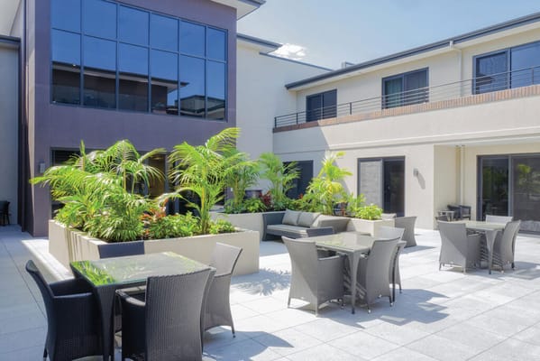 Outdoor courtyard with seating and greenery