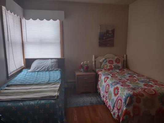 A shared room with two beds and floral decor
