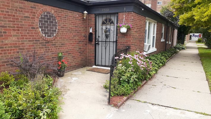 Entrance pathway with flowers and plants