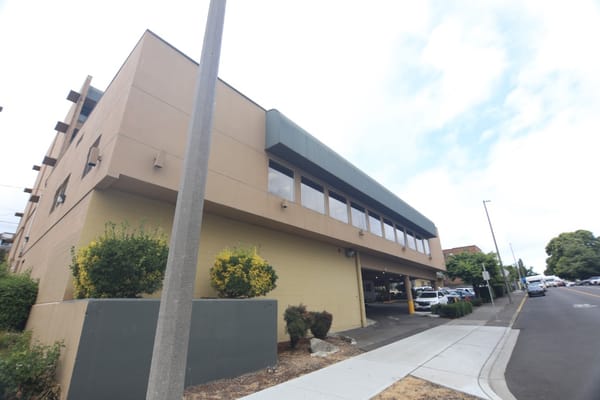 The exterior of Cascade Park Vista, showing the building's facade and entrance.