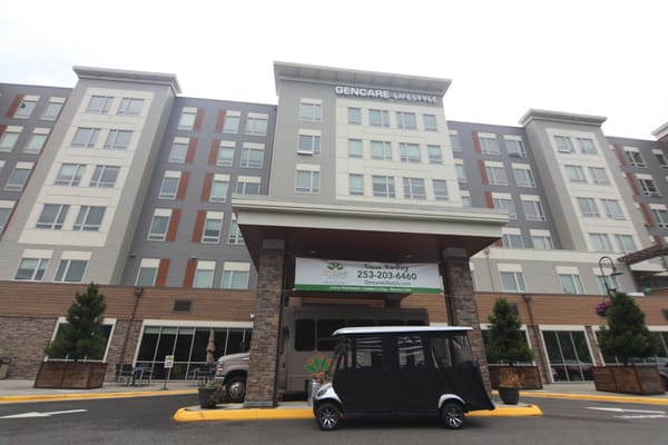 Front view of GenCare Lifestyle Tacoma facility with a transport vehicle