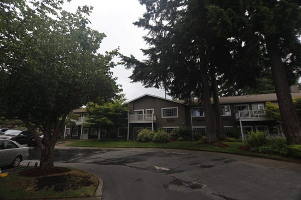 Exterior view of Weatherly Inn Tacoma surrounded by trees