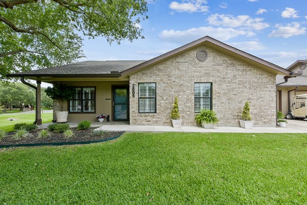 Exterior view of a senior living building with greenery