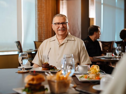 A resident enjoying a meal in the dining area