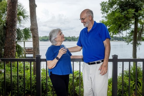 Two residents enjoying the outdoor space by the lake