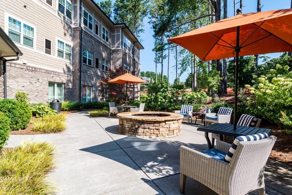 Outdoor seating area with fire pit and umbrellas