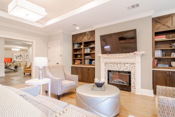 Bright common area with seating and fireplace