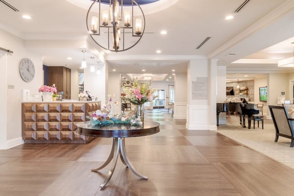 Bright interior common area with residents and decor