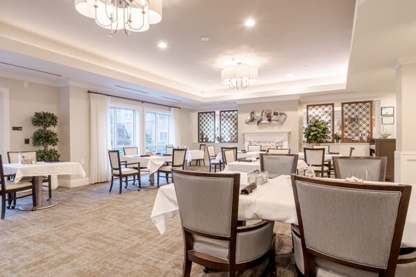 Bright dining area with tables and chairs set up