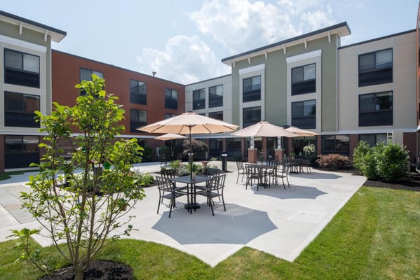 Outdoor seating area with umbrellas and landscaping