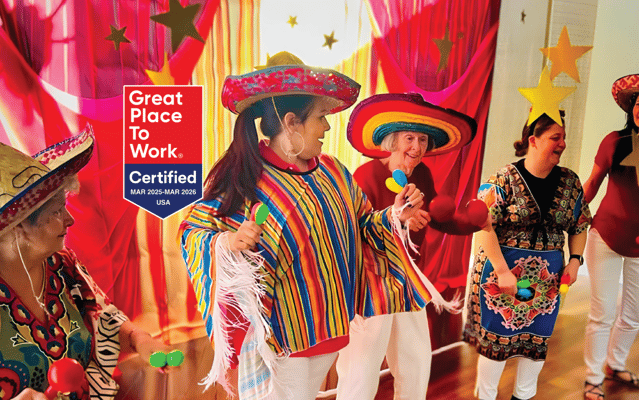 Residents participating in a festive activity with maracas