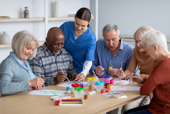 Residents and staff engaged in a creative painting activity
