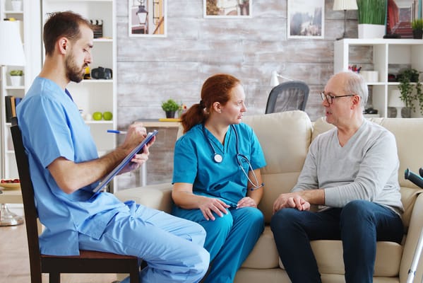 Healthcare professionals interacting with a resident