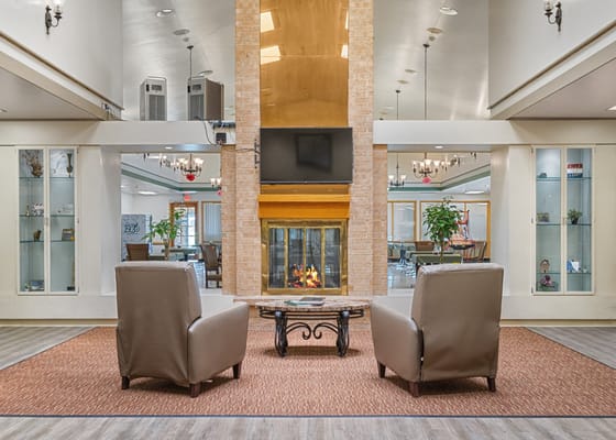 Bright common area with seating and fireplace