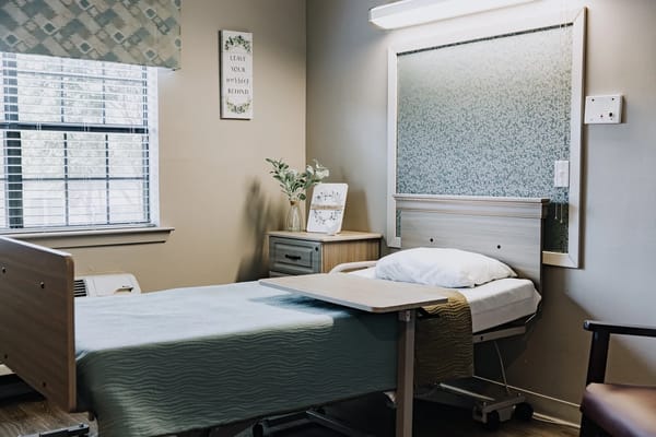 Well-furnished resident room with a hospital bed