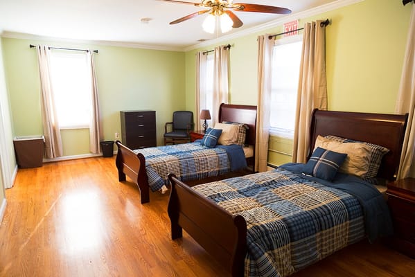 Well-furnished shared resident room with twin beds