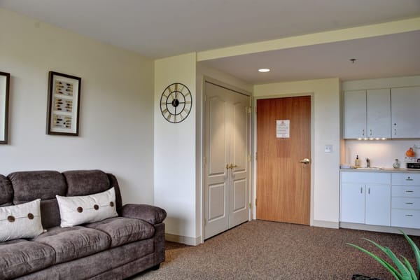 Cozy living area of a resident room with a kitchenette