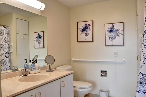 Bright bathroom with floral decor and safety features