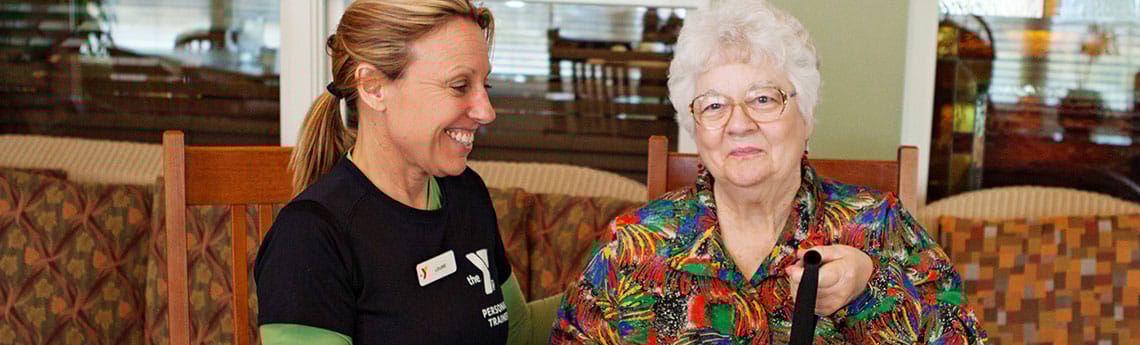 A staff member engaging with a resident in a cozy indoor setting