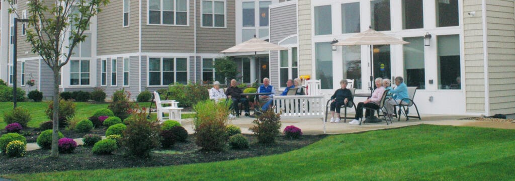 Residents enjoying outdoors in a garden setting
