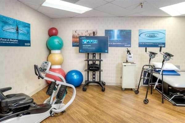 Rehabilitation gym with exercise equipment and motivational posters
