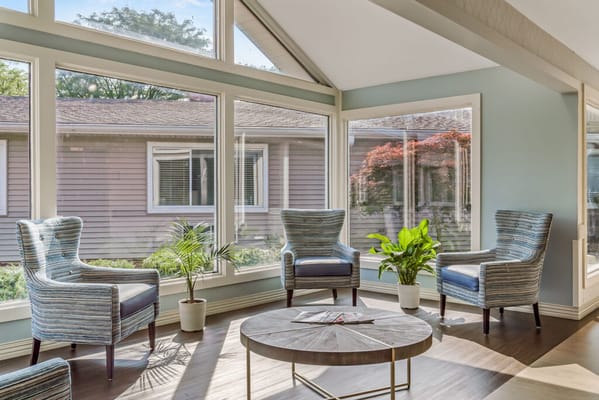 Bright common area with large windows and seating