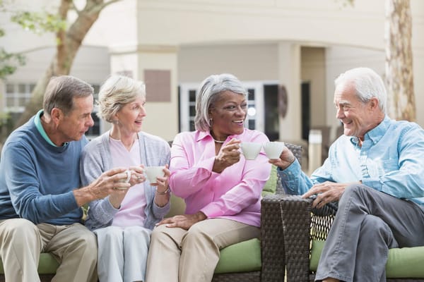 Residents enjoying coffee together in an outdoor space