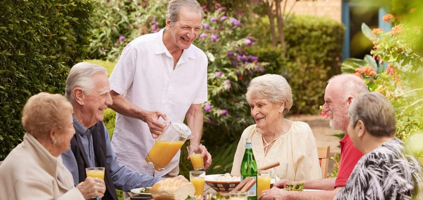Residents enjoying refreshments in a garden setting