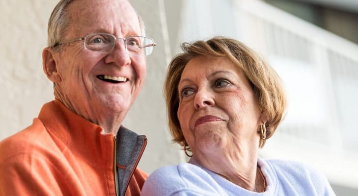 Two seniors smiling together in a cozy setting