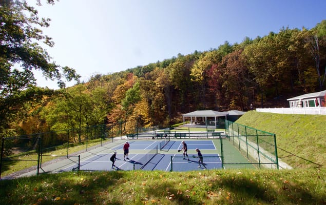 Residents enjoying tennis on a sunny day