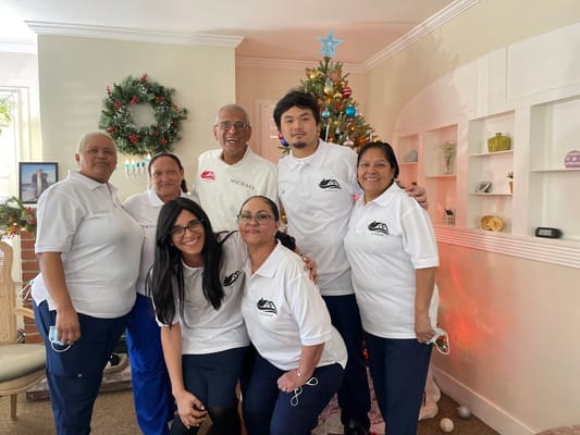 Staff and residents celebrating together in a decorated common area