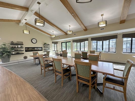 Bright common area with dining tables and chairs