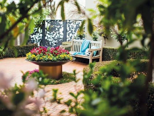 Beautifully landscaped outdoor space with flowers and seating