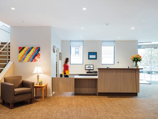 Bright reception area with staff member walking by