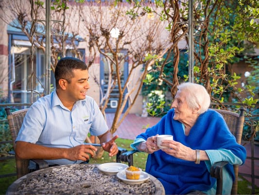 Staff member engaging with a resident outdoors