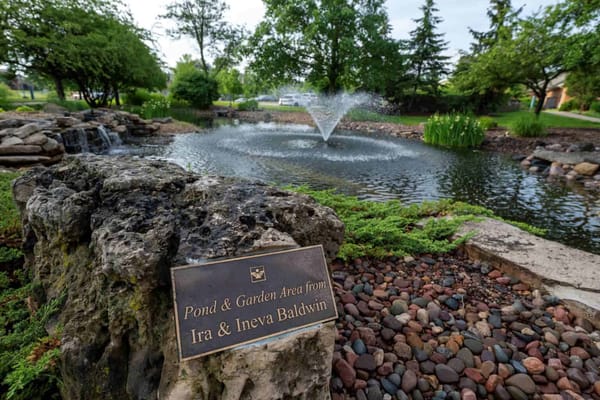 Pond and garden area with a plaque