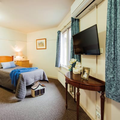 Cozy private resident room with bed and TV