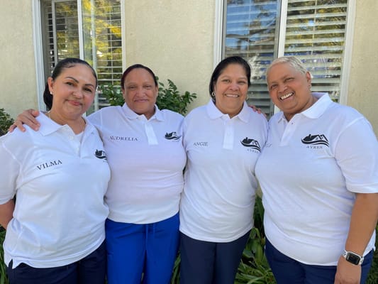 Staff members posing together outside the facility
