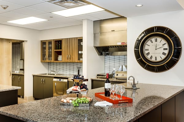 Interior view of a modern kitchen with food and wine