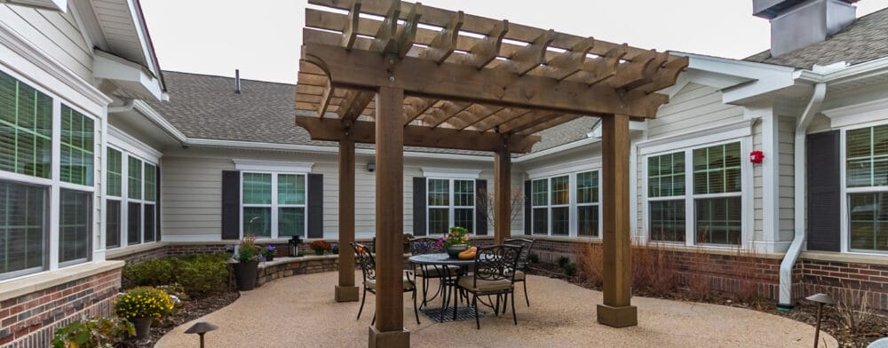 Covered outdoor seating area with landscaping